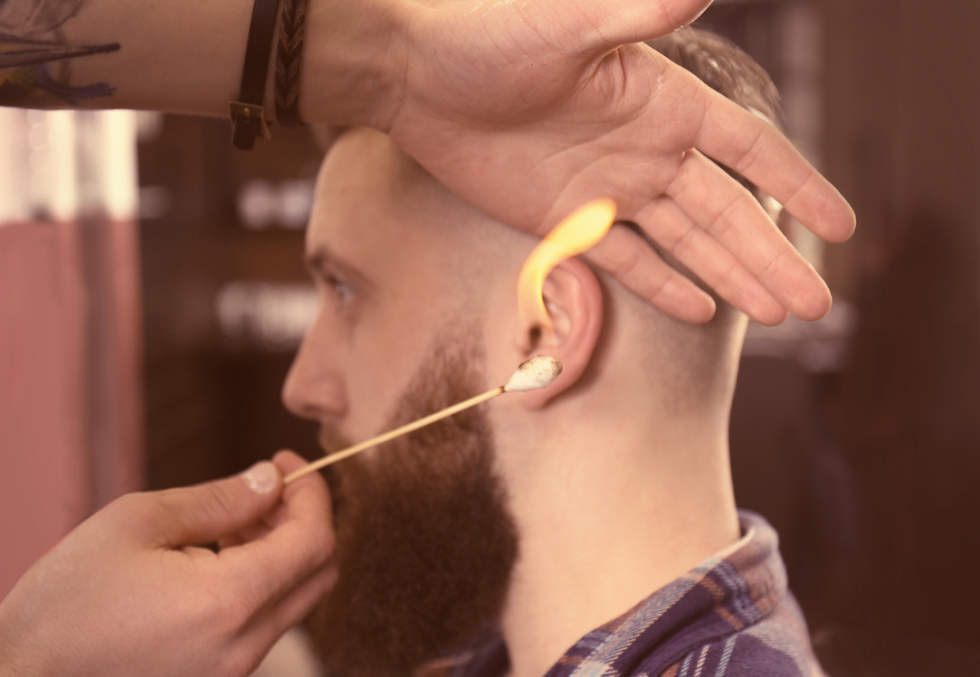 Barber Doing Ear Hair Removal in Barbershop